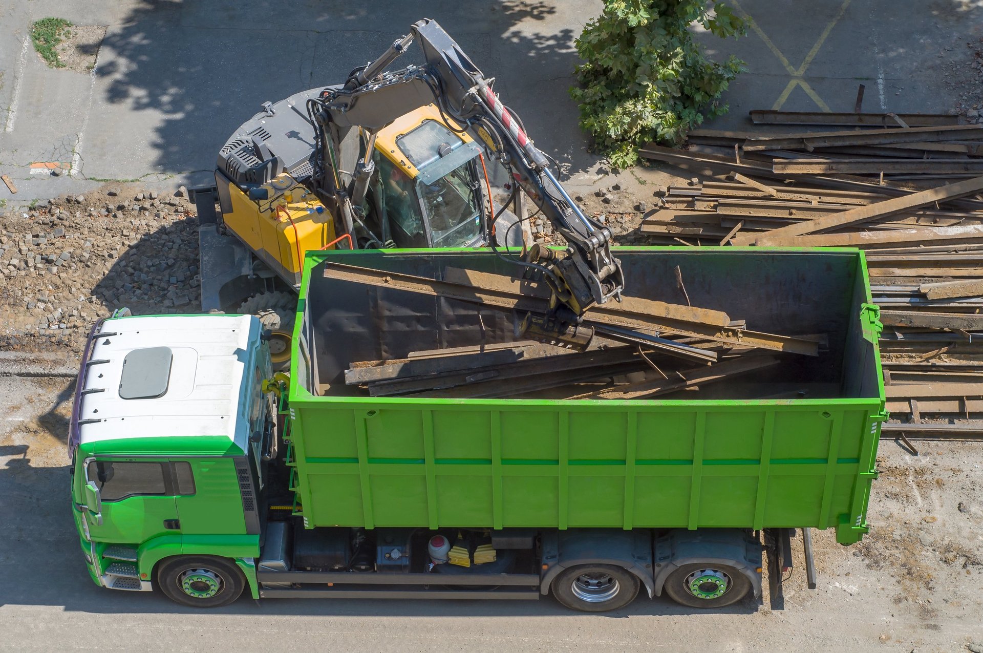A grapple loader loads scrap industrial metal for recycling.
