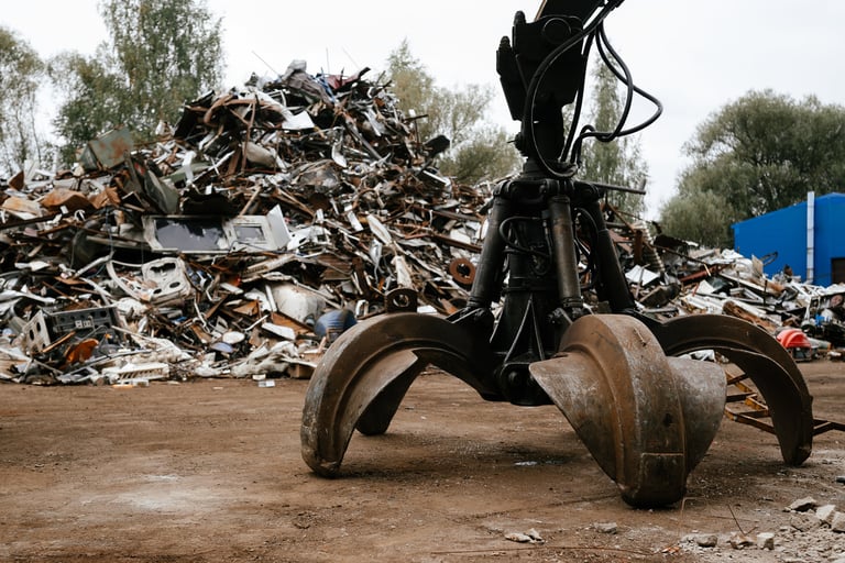 Hydraulic grab machine at industrial scrap yard